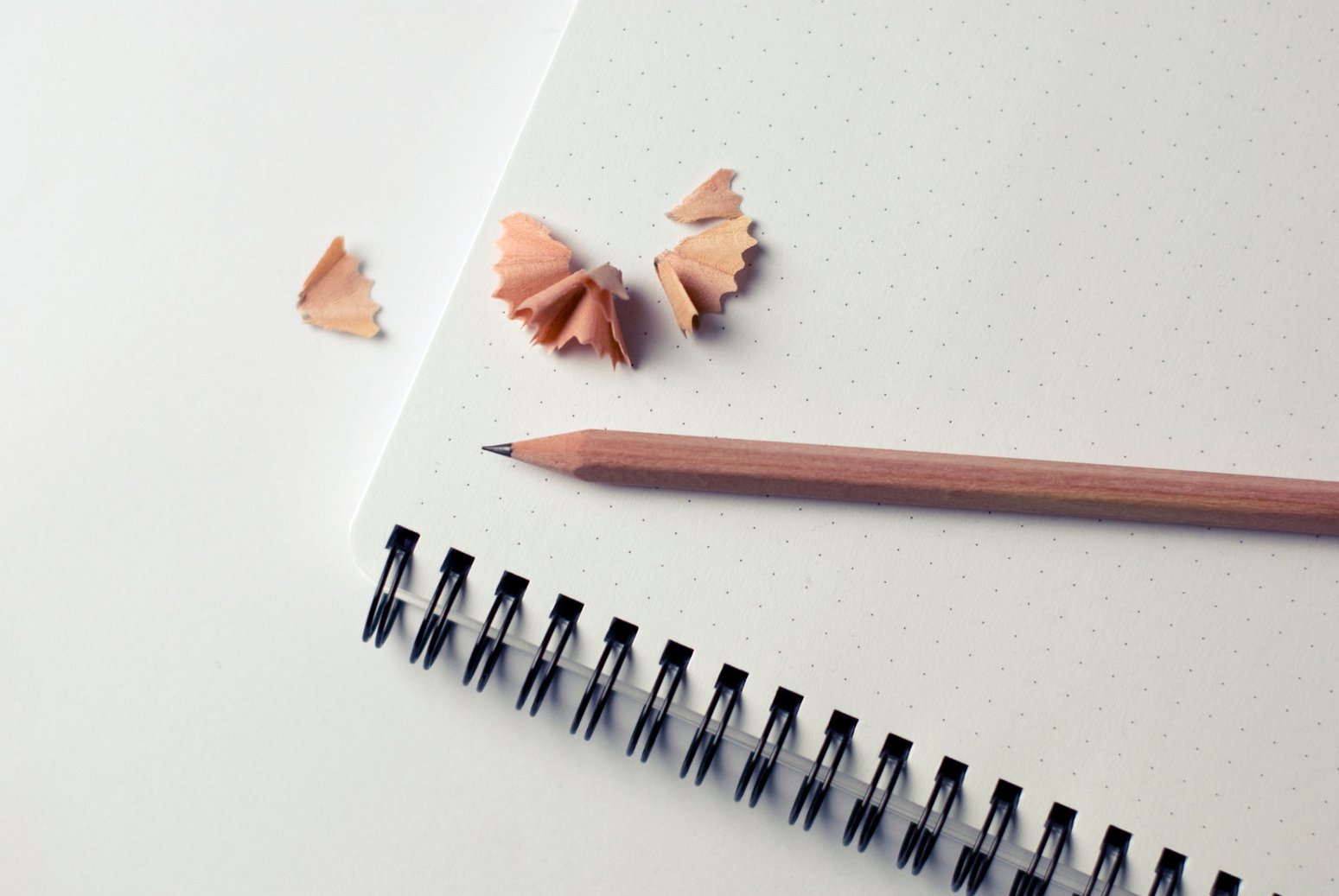 Brown Pencil on White and Black Spiral Notebook